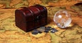 Treasure box and globe on ancient map background Royalty Free Stock Photo
