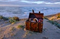 Treasure chest at the beach in a sunrise Royalty Free Stock Photo