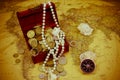 Treasure chest with jewelry and coins, compass and shells on a vintage map