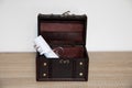 Treasure chest with a rolled blank paper inside of it Royalty Free Stock Photo