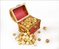 Treasure Coffer full of gold coins, some also outside Royalty Free Stock Photo