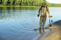 Treasure hunter is looking for a metal detector in the river Royalty Free Stock Photo