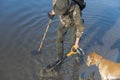 Treasure hunter is looking for a metal detector in the river Royalty Free Stock Photo