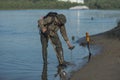 Treasure hunter is looking for a metal detector in the river Royalty Free Stock Photo