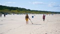 Treasure hunter with metal detector on the beach of Swinoujscie