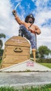 Pirate Statue standing on treasure chest with sword raised to the sky