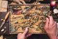 Treasure map in adventurer treasure hunter hands.