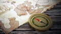 Treasure map and vintage compass standing on old wood table. 3D illustration Royalty Free Stock Photo