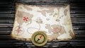 Treasure map and vintage compass standing on old wood table. 3D illustration Royalty Free Stock Photo