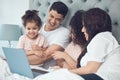 Treasured family time. a beautiful young family talking and bonding in bed together. Royalty Free Stock Photo