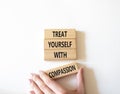 Treat yourself with compassion symbol. Concept words Treat yourself with compassion on wooden blocks. Beautiful white background. Royalty Free Stock Photo