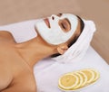 Treating her skin to a pampering mask. a young woman enjoying a facial treatment at a spa. Royalty Free Stock Photo