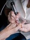 Treatment of the cuticle cutter on the nails of the feet.