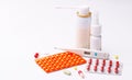 Treatment of flu. Throat spray, nose drops, cold pills and thermometer on white background.