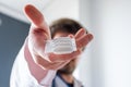 Treatment with medication in form of suppositories concept photo. Doctor holding in his outstretched hand packaging of suppositor