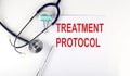 TREATMENT PROTOCOL text written on the paper with a stethoscope. Medical concept