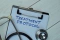 Treatment Protocol write on a paperwork isolated on Wooden Table