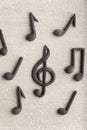 Treble clef and musical notes on beige background. Violin key. CLose up. Top view