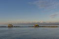 Trebuchet fishing huts against the Alps covered with snow, Marina di Pisa, Tuscany, Italy