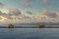 Trebuchet fishing huts at sunset against the Alps covered with snow, Marina di Pisa, Tuscany, Italy