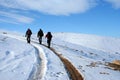 Trecking on snowy path on a sunny winter day Royalty Free Stock Photo