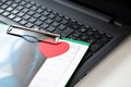 Red heart next to keyboard of laptop, top of view. Concept thank you doctor, medical personnel