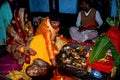 Treditional worshipping of god performing by an Indian Family. The family bearing an Indian dress in suffron colour.