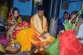 Treditional worshipping of god performing by an Indian Family. The family bearing an Indian dress in suffron colour.