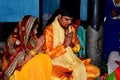 Treditional worshipping of god performing by an Indian Family. The family bearing an Indian dress in suffron colour.