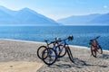 Tree bicycles on the Lago Maggiore promenade in Ascona, Switzerland with view to lake surrounded mountains Royalty Free Stock Photo