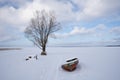 Boat stand on snowy lake and have a blue sky with white clouds