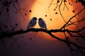 A tree branch cradles affectionate birds in beautiful silhouette