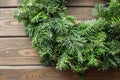 Fir-tree wreath on rustic wooden background used for christmas decoration Royalty Free Stock Photo