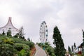 A tree cage and Ferris wheel with a backdrop of slightly cloudy skies Royalty Free Stock Photo