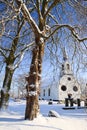 Tree and church in a white winter landscape Royalty Free Stock Photo
