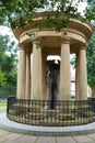 Tree of the city of Guernica protected by stone columns and an iron fence and roofed with a capital