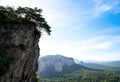 Dramatic Cliff Edge with Tree Overlooking a Mountain Valley Royalty Free Stock Photo