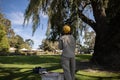 Tree climber standing holding light green rope wearing ear muffs noise hearing protection