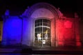 Tree Colors of France on statue of veterans in night