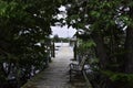 Tree covered deck leading to a pier