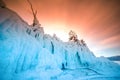 Tree covered with ice and snow at sunset in the shore of the soaring lake Baikal in winter, Siberia, Russia Royalty Free Stock Photo