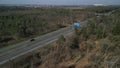 Sick trees on a highway with heavy traffic seen from the air with a drone