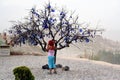 Tree decorated with Evil Eyes, in the valley of Uchisar in Cappadocia , Turkey