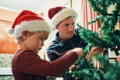 On tree decorating duty. an adorable little boy decorating the Christmas tree with his father at home. Royalty Free Stock Photo