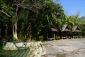 Tree-lined swimming pool and wooden house gazebo Royalty Free Stock Photo