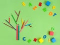 Tree made from color pencils with ABC letters on green background Royalty Free Stock Photo