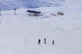 Tree mans skiing down on hil on stantion background in Caucasus, Gudauri Royalty Free Stock Photo