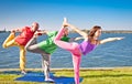 Tree people practice Yoga asana at lakeside. Yoga concept.