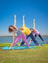 Tree people practice Yoga asana on lakeside. Yoga concept.