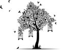 Tree silhouette with birds flying and bird in a cage